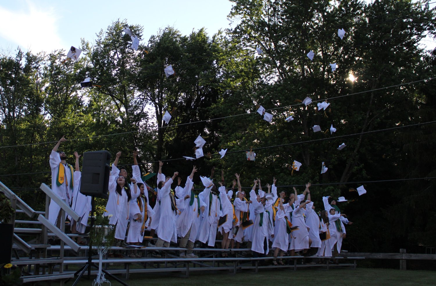 The Grads of Eldred Junior Senior High School toss their caps in the air.